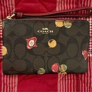 Coach Brown & Black C Logo Wristlet with Red, Gold, and Green Ornament Accents.